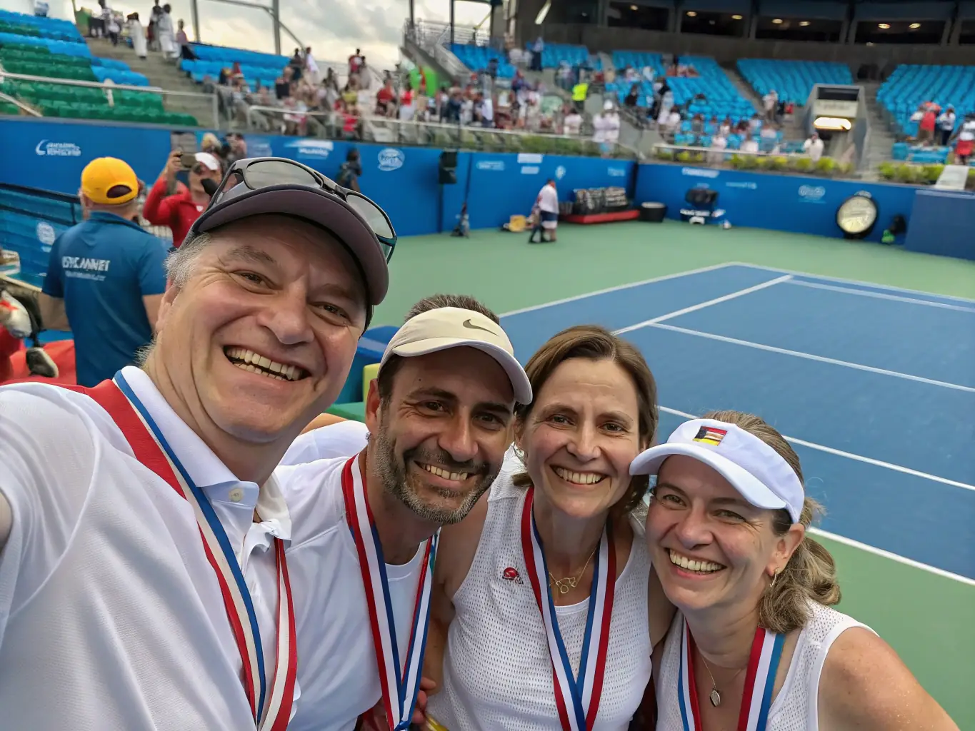 A team of tennis players celebrating a victory, showcasing teamwork and camaraderie, with the K&A Tennis Club logo subtly visible in the background.